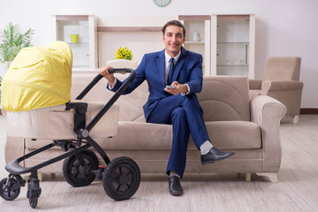 Young businessman looking after baby