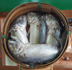 Steamed mackerel fishes in bamboo basket for sale at the market. Basket of steamed mackerel for...