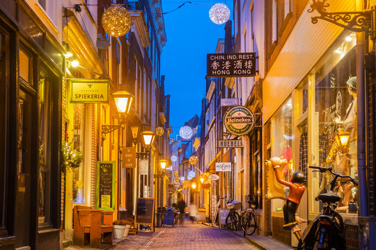 Colorful shopping street with christmas decoration in the ancient city center of Leiden, The Netherlands on January 16, 2020