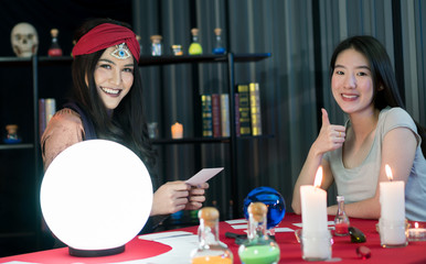 The fortune teller is predicting the fortune.