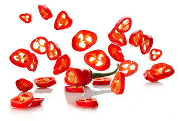 Chili pepper and its slices close-up falling