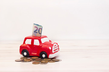 Obraz na płótnie Canvas money and coins in a piggy bank in the form of a car. copyspace. The accumulation of money to buy a car. Saving money for a dream. Buying a car.