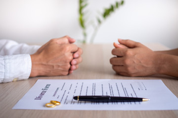 The hands of the wife and husband with the order of divorce, dissolution, cancellation of marriage,...