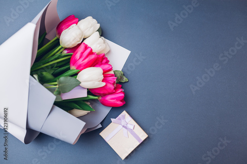 Spring flowers with gift box. Women's day background. Bouquet of white and ping tulips. Present for Mother's day