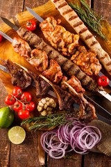 Fresh, homemade beef kebab with vegetables and spices, with barbecue sauce and ketchup