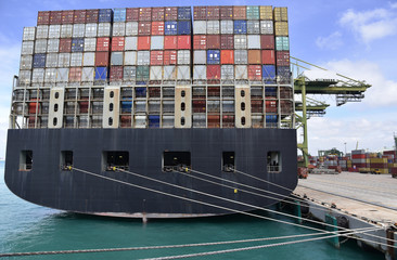 Fully loaded container ship berthed in the international container terminal in Singapore. View on...