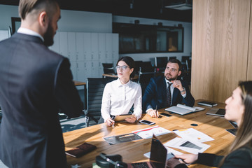 Team of executives listening to colleague