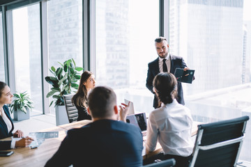 Confident CEO giving speech to employees - obrazy, fototapety, plakaty