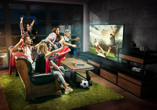 Group Of Friends Watching TV, Match, Championship, Sport Games. Emotional Men And Women Cheering For Favourite Team, Look On Fighting For Ball. Concept Of Friendship, Sport, Competition, Emotions.