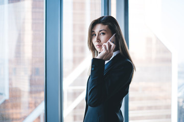 Elegant businesswoman having phone call in workplace