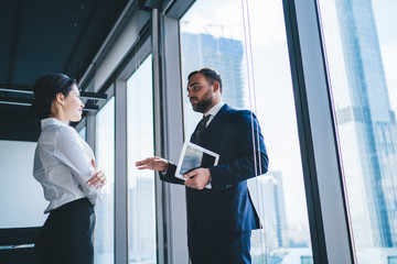 Businesswoman talking to male CEO with tablet