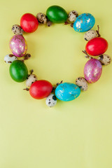 Top view painted eggs Easter Frame in circle shape on a yellow background. Copy space