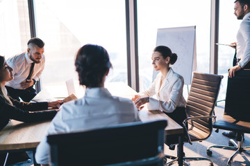 Focused colleagues communicating in office
