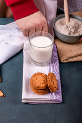 Cup of milk with cinnamon biscuits and flour