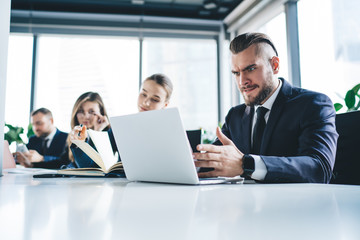 Shocked businessman working on computer at table