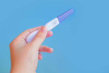 Positive pregnancy test with two strips on pink