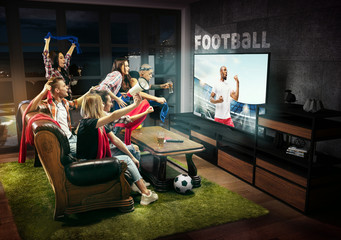 Fototapeta na wymiar Group of friends watching TV, match, championship, sport games. Emotional men and women cheering for favourite football team, look on player. Concept of friendship, sport, competition, emotions.