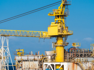 Image of big heavy yellow crane working in cargo port terminal