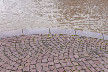 Embankment. Red granite and water. close-up . vintage. background.