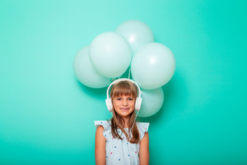 Child wearing headset and listening to the music