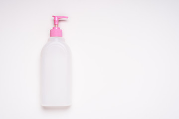 top view white empty plastic cleaning product bottle with pink lid and dispenser on white background for branding