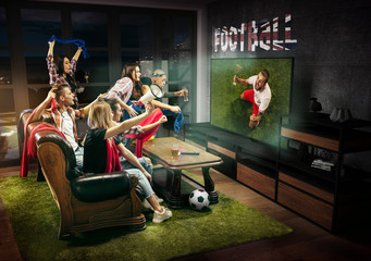 Group of friends watching TV, match, championship, sport games. Emotional men and women cheering for favourite soccer team on Great Britain with flag. Concept of friendship, sport, competition