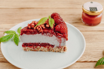 Raw dessert. Cake with berries and nuts, on a wooden background