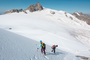 Mountaineering team descending down a snowy mountain face in the Mont Blanc Massif