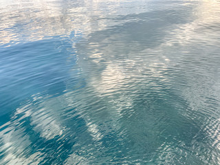 Surface of the sea water background, reflection on the water, natural colors
