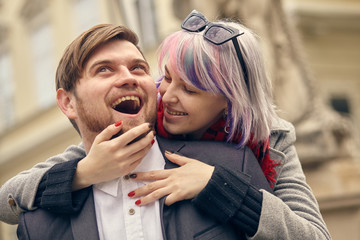 couple in love outdoor.Stunning sensual outdoor portrait of young stylish fashion couple posing in spring in city