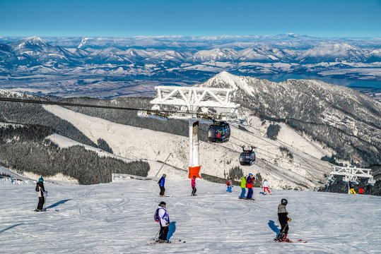 Skiers on slope at ski resort Jasna in Low Tatras mountains at SLovakia