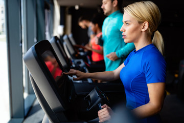 Fototapeta premium Young attractive woman doing cardio training in gym