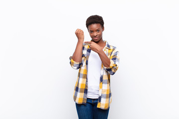 young pretty black womanlooking impatient and angry, pointing at watch, asking for punctuality,...