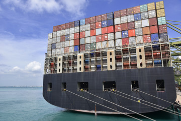 Fully loaded container ship berthed in the international container terminal in Singapore. View on...