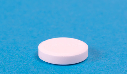 Obraz na płótnie Canvas Pill isolated on blue background
