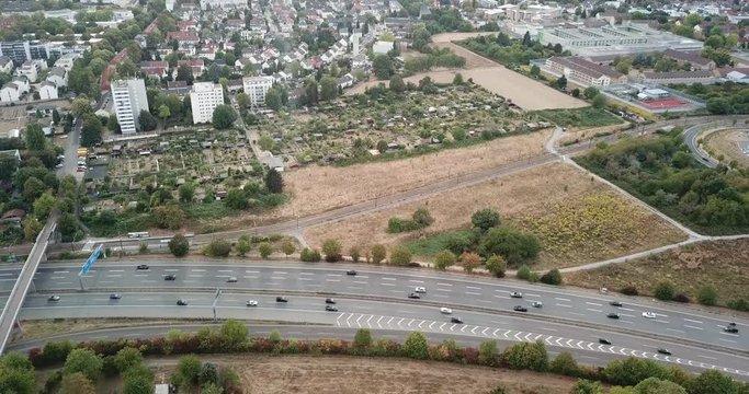 Aerial view of city landscape with autobahn motorway in metropolis, Bird's eye. Automobiles moving at street with modern automotive expressway. interchange road highway, junctions freeway