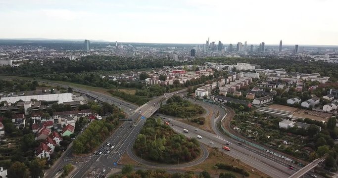 Aerial view of city landscape with autobahn motorway in metropolis, Bird's eye. Automobiles moving at street with modern automotive expressway. interchange road highway, junctions freeway