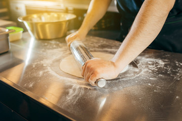 Chef preparing dough in a kitchen