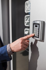 Man hand pressing the security code combination to unlock the door