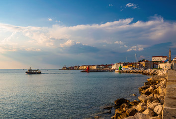 Harbour of Piran, Slovenia. Historic old buildings and St. George's Parish Church with italian...