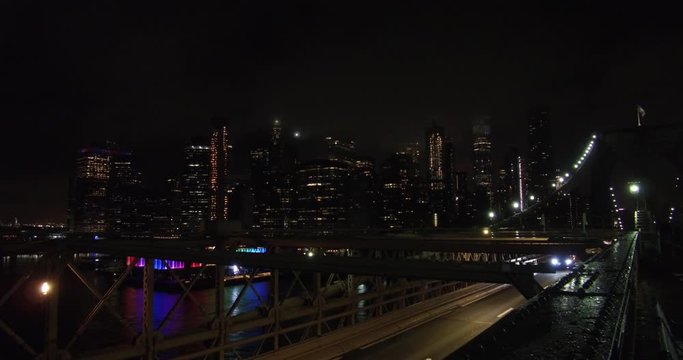 Financial District of New York after the rain at late night, view from the Brooklyn Bridge.