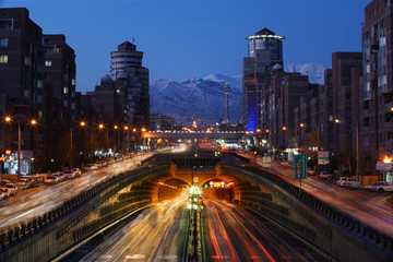 Fototapeta na wymiar An Expressway and Underground tunnel in Tehran and a long exposure View of of mountains at the front just after the sunrise.
