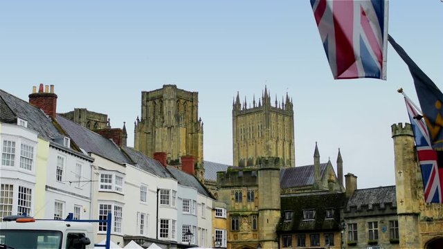 Union Jacks flutter in the foreground of this typically Enghlish view across Wells market place towards the Cathedral, in England's smallest city