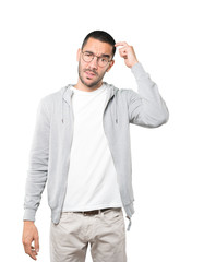 Fototapeta premium Concerned young man doing a gesture of confusion