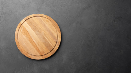 Top view on empty wooden round cutting board on black background with copy space. Restaurant menu or recipe mockup.