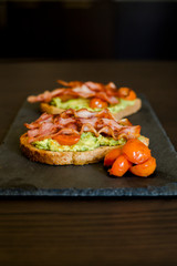 avocado toast with cherries tomatoes and bacon