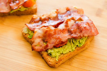 avocado toast with cherries tomatoes and bacon