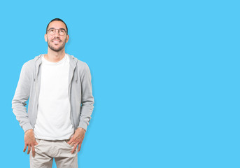 Happy young man looking against background