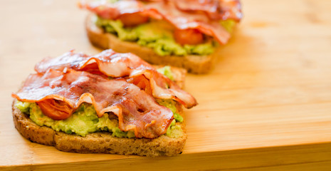 avocado toast with cherries tomatoes and bacon