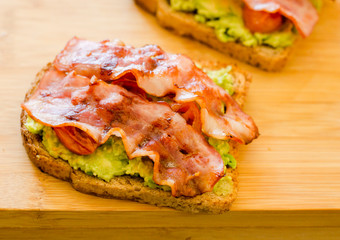 avocado toast with cherries tomatoes and bacon